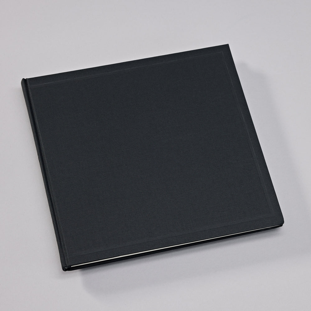 Black linen-bound book on a light gray background