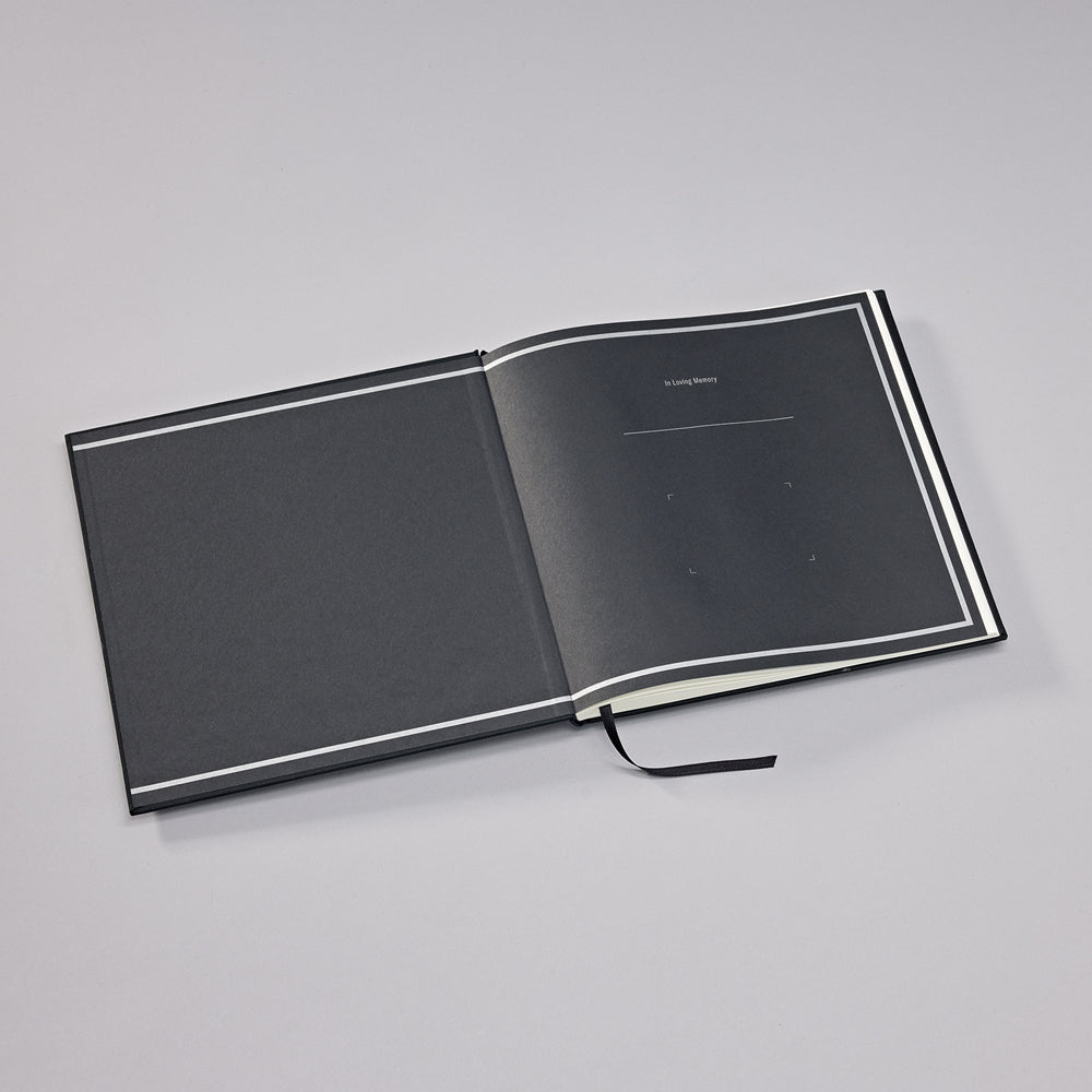 Open black notebook on a gray background