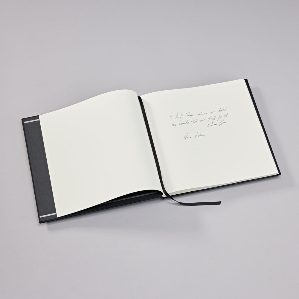 Open notebook with handwritten text on a gray background